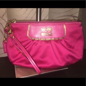 Bright pink Coach wristlet